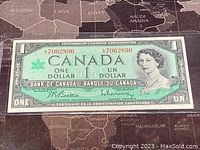Front side of the 1967 Canadian one dollar banknote showing portrait of Queen Elizabeth II, serial number and text in English and French.