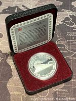 1986 Canadian silver proof dollar coin in original velvet-lined case with Royal Canadian Mint insert card.