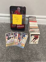 Full hockey card lot consisting of a metal tin labeled 'Series 2 Complete Set' containing the 2015-16 Upper Deck Series 2 hockey card collection with a separate stack of vintage hockey cards and several cards laid out in front.