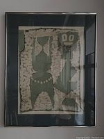 Framed lithograph artwork showing abstract figure with necklace and smaller figure, muted colors.