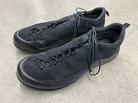Side view of the black Arc'teryx Konseal FL 2 shoes showing leather upper and lacing detail.