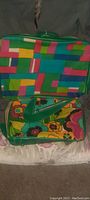 Open large floral print carry bag showing interior lining with geometric pattern