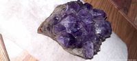 Top and angled view showing deep purple amethyst crystals clustered on stone base.