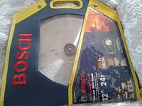 Front of custom carry case with Bosch branding and clear window showing the circular saw blade and product details.