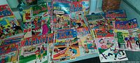 Wide view of 32 comic books laid out, showing variety including Jughead, Archie, Betty and Veronica, Reggie, Mad House, Laugh
