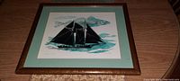 Full view of the framed sailboat artwork "Schooner" showing solid wood frame and mat, artwork centered under glass.