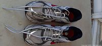 Top view of Nike Zoom men's running shoes size 12 showing gray mesh upper, red swoosh, and long laces untied.