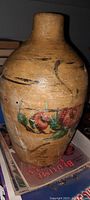 Photo of stoneware gallon jug showing neck and painted floral design on the body