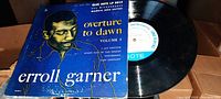 LP record with Blue Note label and catalog 5014 beside original cardboard sleeve featuring blue background and gold line drawing of Erroll Garner