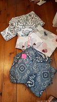 All three duvet cover sets laid flat on wood floor