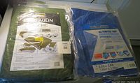 Photo showing both tarps in original packaging with labels visible.