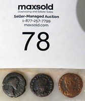 Three ancient Roman bronze coins shown from obverse side with Roman figures' profiles visible.