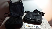 Photo showing three black handbags: one Nine West handbag with short handles, one Rosetti multi-zip handbag, and one black nylon multi-slot bag.
