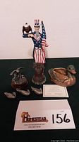 Photo showing complete lot including Lenox Freedom's Pride porcelain sculpture holding bald eagle and flag, several pewter bird figurines including the three George de Lodzia ducks, Ringneck Pheasant, and a vintage ceramic duck planter.