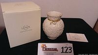 Photo showing Lenox box, certificate of authenticity, and the Mother's Day 2011 vase on a black surface.