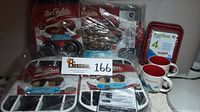 Photo showing all listed bakeware items from Mrs. Fields, Anchor TrueSeal covered casseroles, and Starbucks Washington mugs grouped together in packaging.