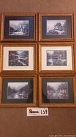 Full view of six framed Thomas Kinkade prints arranged in two columns and three rows with visible matting and gold frames.
