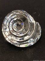 Top and angled close-up view of the clear faceted Swarovski crystal sea shell figurine.
