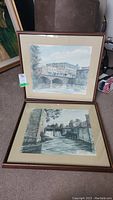 Two framed and matted prints displayed on carpet showing Rideau River scenes by Ben Babelowski.