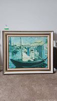 Full front view of the framed painting showing the scene of two figures in a boat on water with distant landscape.
