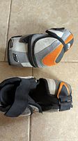 Top and side views of junior large hockey elbow pads showing Sonic brand and size tags