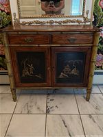 Front view of Chinoiserie style entryway table with two decorative doors and faux bamboo legs on tiled floor.