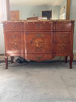 Front view of Louis XV style dresser showing marble top and marquetry veneer with visible chips and damage.