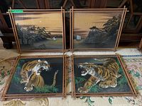 Four framed Japanese watercolor paintings displayed on floor, showing two landscape scenes and two tiger scenes, all under bamboo-style wood frames.