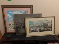 Three paintings arranged together showing frames and artwork details