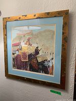 Full view of the framed print showing the royal elephant procession scene with gold mottled frame and blue matte border.