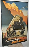 Framed vintage poster showing a Canadian Pacific locomotive train in front of stylized mountains under blue sky, with advertising text for travel across Canada.