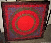 Frontal view of framed abstract concentric circle painting