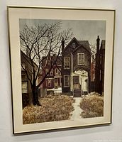 Framed print showing a residential street scene with houses and leafless tree by Albert Frank