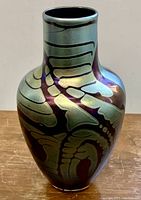 Angled front view of vase showing shape and iridescent pattern.