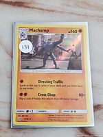 Photo of the Machamp Rare Holo Pokemon Card front face showing details and holo effect