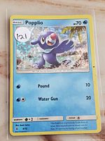 Holographic Popplio Pokemon card with visible condition and details
