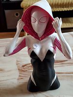 Front view of the Spider-Gwen coin bank figure showing costume details and pose.
