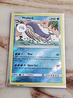 Front of the Wailord Reverse Holo Pokémon card showing condition, image, and text of moves, HP, and details.