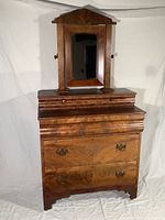 Full front view of the antique tiger maple veneer chest with five drawers and flip mirror. Shows overall construction, wood grain finish, and decorative mirror mounting.