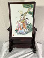 Front view of milk glass plaque in wood stand