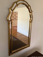 Front view of the vintage Ethan Allen mirror showing full gold wood frame and reflective surface