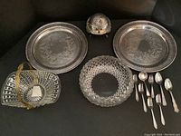 Full lot showing all items: two silver plates, two glass fruit bowls, butter dish, and cutlery