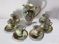 Full set including chocolate pot, 6 cups and 6 saucers arranged on white surface