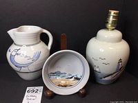 Photo showing all three pottery pieces together: lamp, pitcher, and bowl.