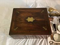 Top view of wooden box showing brass inlay and removable brass plate on top