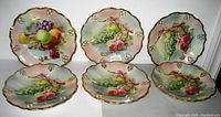 Front view of six signed Dresden Germany porcelain plates with pierced rims and hand-painted fruit decoration in pastel tones arranged in two rows of three