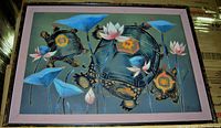 Frontal view of the oil painting showing native turtles amidst waterlilies in a pink and dark frame.