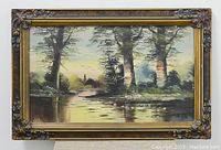 Full view of the oil painting on canvas framed in an ornate dark wood and gold Art Nouveau style frame, showing a marsh scene with trees and water.