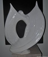 Front-facing photo of the large white glazed porcelain Art Deco dancing lady figurine with stylized flowing dress.