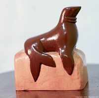 Front view of the mid-century modern walrus woodcarving on block base.
